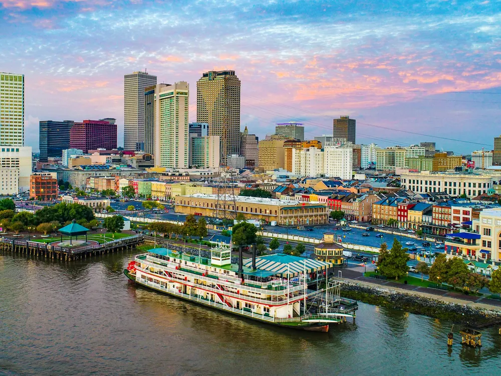 The New Orleans skyline and a paddle steamer on the Mississippi River at sunset